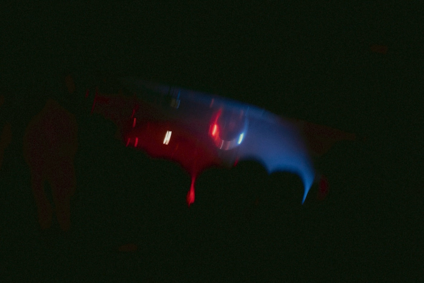 Red and blue lights blurred across a dark club floor at an A.S.F. night